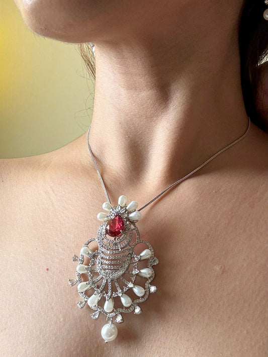 Shop Ruby Love Floral Pendant Set In AD & Pearls Online in India. Pendant sets in different stones like Kundan, Moissanite, CZ stones and AD stones in all kinds quality are available online for purchase on website. Explore pendant sets for festive occasions perfect mothers and elderly ladies too. Pendant sets in green, blue, pink, red and white stones are available for wearing with sarees, lehengas, suits and Indo-westerns. -side