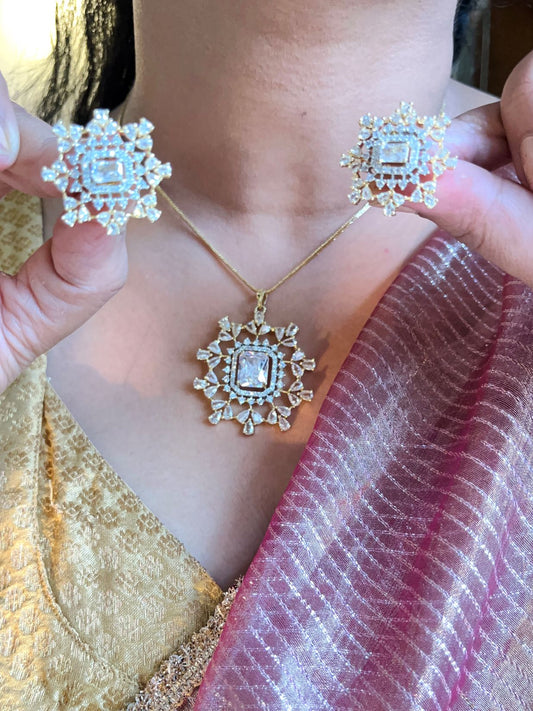 Shop Rekha Floral Pendant Set With Studs In Gold Polish Online in India. Pendant sets in different stones like Kundan, Moissanite, CZ stones and AD stones in all kinds quality are available online for purchase on website. Explore pendant sets for festive occasions perfect mothers and elderly ladies too. Pendant sets in green, blue, pink, red and white stones are available for wearing with sarees, lehengas, suits and Indo-westerns. -first