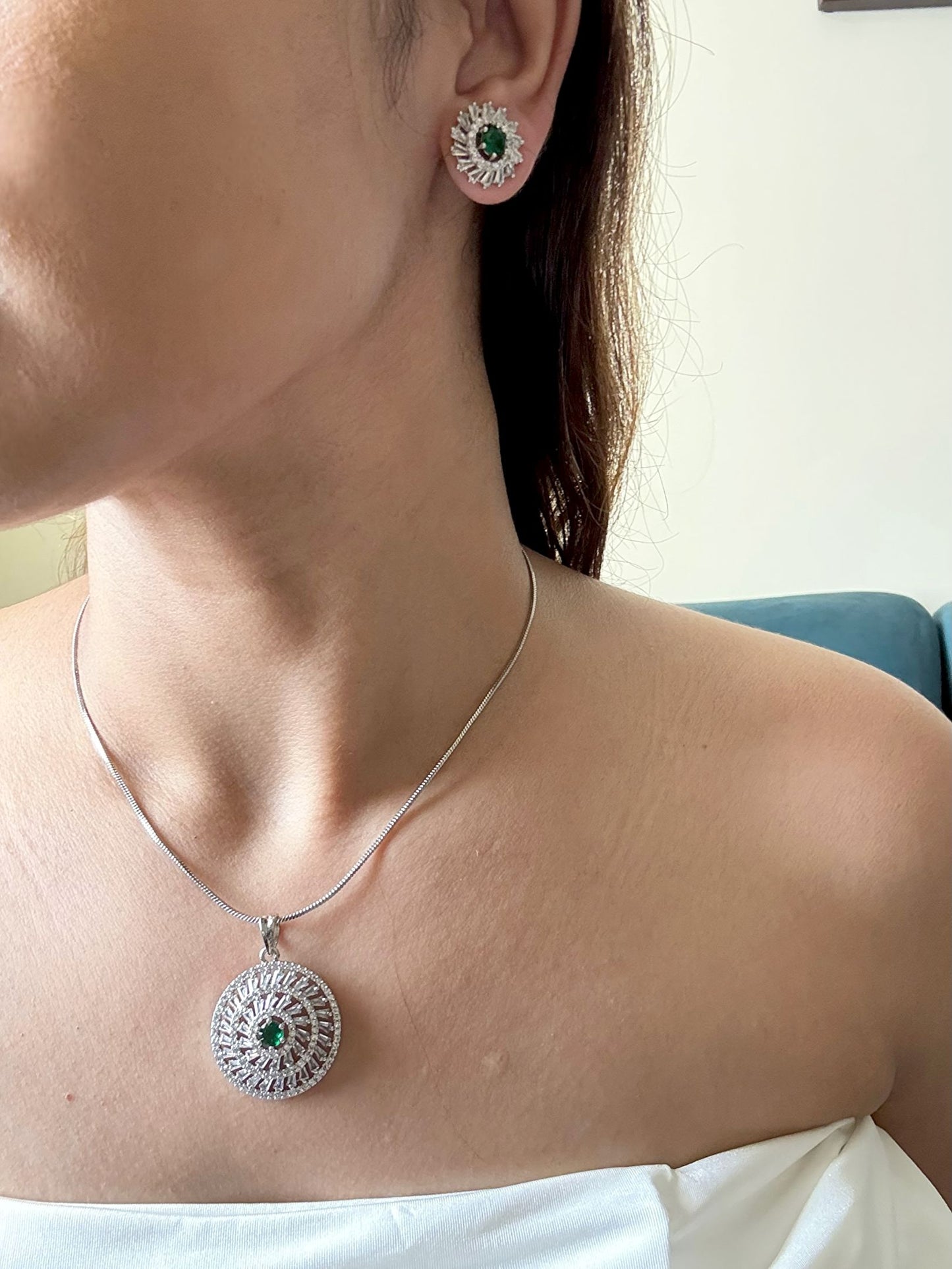 Shop Kiara Round Pendant Set With Studs In AD & Green Stone Online in India. Pendant sets in different stones like Kundan, Moissanite, CZ stones and AD stones in all kinds quality are available online for purchase on website. Explore pendant sets for festive occasions perfect mothers and elderly ladies too. Pendant sets in green, blue, pink, red and white stones are available for wearing with sarees, lehengas, suits and Indo-westerns. -first