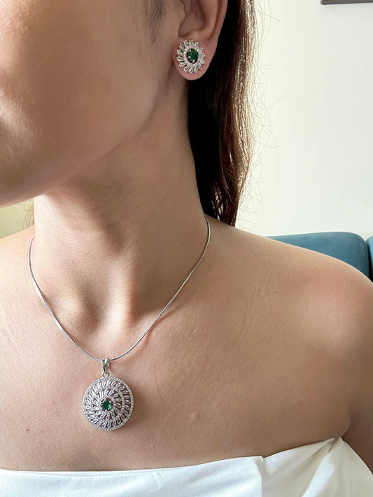 Shop Kiara Round Pendant Set With Studs In AD & Green Stone Online in India. Pendant sets in different stones like Kundan, Moissanite, CZ stones and AD stones in all kinds quality are available online for purchase on website. Explore pendant sets for festive occasions perfect mothers and elderly ladies too. Pendant sets in green, blue, pink, red and white stones are available for wearing with sarees, lehengas, suits and Indo-westerns. -first